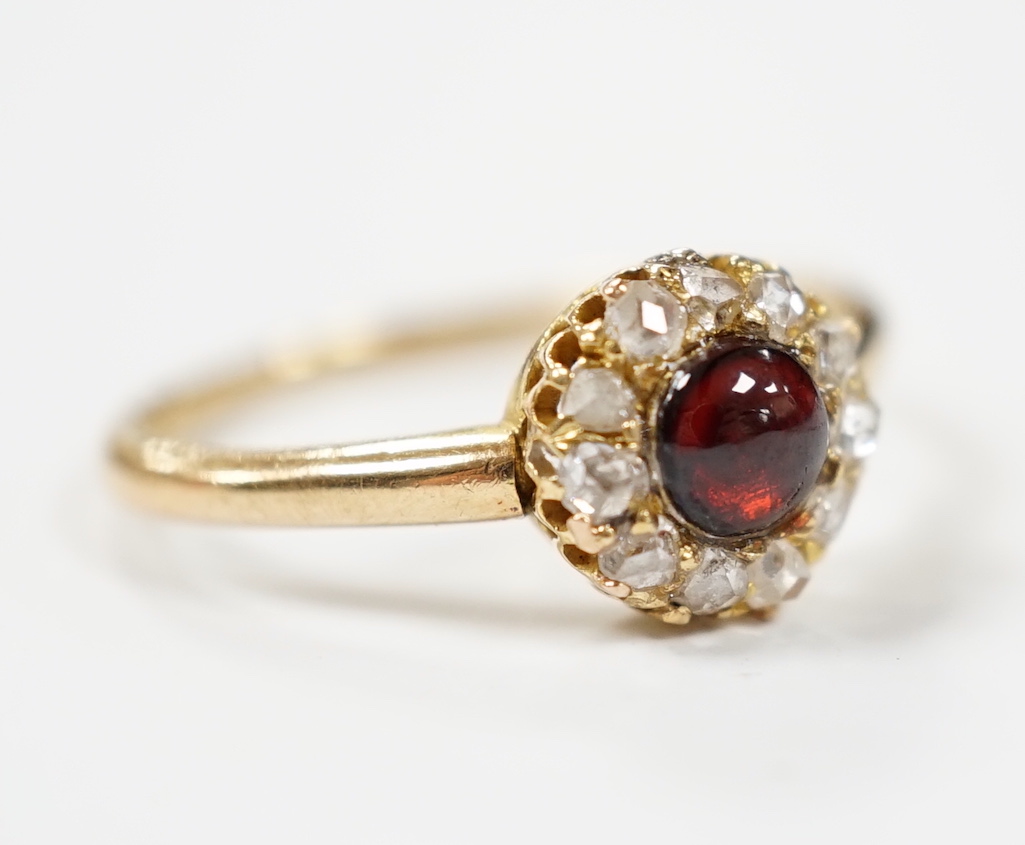 An 18ct, foil backed cabochon and diamond cluster set dress ring, by Annina Vogel, size M/N, gross weight 2.7 grams.